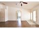 Spacious living room with wood floors, ceiling fan, and an archway leading to other rooms at 6016 Bungalow Bay St, Las Vegas, NV 89130