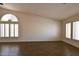 Bright living room featuring arched windows, and wood-look flooring at 6016 Bungalow Bay St, Las Vegas, NV 89130