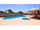 Wide angle of backyard featuring large pool and hot tub combo at 6016 Bungalow Bay St, Las Vegas, NV 89130