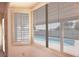View of the backyard pool through the window with shutters allowing light and privacy at 6016 Bungalow Bay St, Las Vegas, NV 89130
