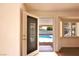 View from inside the house, showcasing the backyard pool visible through the screen door at 6016 Bungalow Bay St, Las Vegas, NV 89130