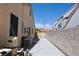 Side yard of the property featuring RV parking, utilities, and wall at 6016 Bungalow Bay St, Las Vegas, NV 89130