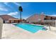 Inviting community pool with clear blue water, surrounded by a spacious patio and safety fencing at 613 Cervantes Dr, Henderson, NV 89014