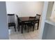 Dining area with tiled floor, dark wood table and chairs, and view into the kitchen at 613 Cervantes Dr, Henderson, NV 89014