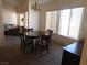 Sunlit dining room features a round table with chairs and large windows with blinds at 613 Cervantes Dr, Henderson, NV 89014