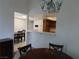 Open dining area with a view into kitchen featuring white countertop and wooden cabinets at 613 Cervantes Dr, Henderson, NV 89014