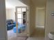 Bright hallway leads to a living room with a comfortable blue couch and accent bench at 613 Cervantes Dr, Henderson, NV 89014