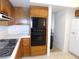 Kitchen with wooden cabinets, appliances, white countertops, and access to dining area at 613 Cervantes Dr, Henderson, NV 89014