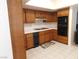 Well-lit kitchen featuring wooden cabinets, tiled countertops, and essential appliances at 613 Cervantes Dr, Henderson, NV 89014