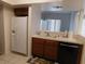 Functional kitchen featuring wooden cabinets, white appliances, and adjacent dining area at 613 Cervantes Dr, Henderson, NV 89014