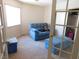Inviting living room with a soft blue couch, bench and ample natural light at 613 Cervantes Dr, Henderson, NV 89014