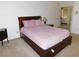 Spacious main bedroom has soft lighting, a comfortable bed and dark wood furniture at 613 Cervantes Dr, Henderson, NV 89014