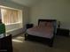 Bright main bedroom with a comfortable bed and a large window for natural light at 613 Cervantes Dr, Henderson, NV 89014