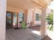 Covered outdoor patio has views to the rock landscaped backyard, exterior window and sliding glass door at 613 Cervantes Dr, Henderson, NV 89014