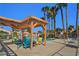 Community pool with shaded seating area and multiple lounge chairs at 613 Cervantes Dr, Henderson, NV 89014