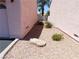Well-kept side yard with low-maintenance gravel, offering a clean and tidy exterior view at 613 Cervantes Dr, Henderson, NV 89014