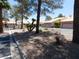 Charming street view framed by mature trees, enhancing the community's serene atmosphere at 613 Cervantes Dr, Henderson, NV 89014