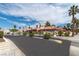 Scenic street view showcasing well-maintained homes, lush palm trees, and inviting sidewalks at 613 Cervantes Dr, Henderson, NV 89014