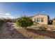 Lovely backyard displaying landscaping, a brick pathway, lush green lawn, and the exterior of the house at 6333 Orto Vaso Ave, Las Vegas, NV 89131