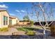 Green artificial turf lawn with drought resistant landscaping and an intricate brick walkway at 6333 Orto Vaso Ave, Las Vegas, NV 89131