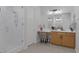 The primary bathroom has a glass shower, oak vanity with double sink, and make up area at 6333 Orto Vaso Ave, Las Vegas, NV 89131