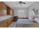 Bedroom with built-in shelves, ceiling fan, desk, and a saxophone decoration on the wall at 6333 Orto Vaso Ave, Las Vegas, NV 89131