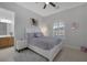 Cozy bedroom with white bed frame, arched window, and attached bathroom at 6333 Orto Vaso Ave, Las Vegas, NV 89131