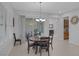 Dining area with a sliding glass door to patio, chandelier lighting and seating for six at 6333 Orto Vaso Ave, Las Vegas, NV 89131