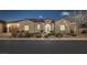 Charming single-story home featuring a tile roof, arched windows, manicured landscaping, and a two-car garage at 6333 Orto Vaso Ave, Las Vegas, NV 89131