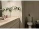 Bathroom with vanity, toilet, and decorative floral accents at 6361 Copperfield Ave, Las Vegas, NV 89108