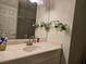 Bathroom with vanity, mirror with floral accents, and toilet at 6361 Copperfield Ave, Las Vegas, NV 89108