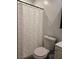 Bathroom featuring a toilet and shower with patterned curtain at 6361 Copperfield Ave, Las Vegas, NV 89108