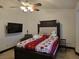 Bedroom features a large bed, ceiling fan, and mounted TV for a relaxing space at 6361 Copperfield Ave, Las Vegas, NV 89108