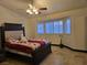 Bedroom featuring a spacious bed, shuttered bay window, and ceiling fan at 6361 Copperfield Ave, Las Vegas, NV 89108