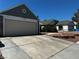Exterior view of house with large driveway, front yard, and two car garage at 6361 Copperfield Ave, Las Vegas, NV 89108