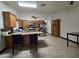 Bright kitchen with wooden cabinets, granite countertops, stainless steel appliances, and tile flooring at 6361 Copperfield Ave, Las Vegas, NV 89108