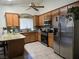 Bright kitchen with stainless steel appliances, granite countertops, wood cabinets and tile flooring at 6361 Copperfield Ave, Las Vegas, NV 89108