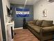 Living room with comfortable couch and wall mounted television at 6361 Copperfield Ave, Las Vegas, NV 89108