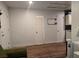 Living room with wood flooring, and multiple doors at 6361 Copperfield Ave, Las Vegas, NV 89108