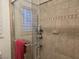 Walk-in shower with clear glass doors and decorative tiled walls at 6361 Copperfield Ave, Las Vegas, NV 89108