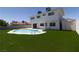 Beautiful backyard showcasing a private pool and lush green turf at 637 Otono Dr, Boulder City, NV 89005