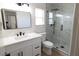 Modern bathroom featuring shower with glass door, white marble counters, and black fixtures at 637 Otono Dr, Boulder City, NV 89005