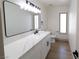 Modern bathroom featuring white countertop vanity, a sleek mirror, and contemporary fixtures at 637 Otono Dr, Boulder City, NV 89005
