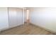Bright bedroom featuring wood-look floors, a closet, and neutral walls at 637 Otono Dr, Boulder City, NV 89005