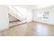 Spacious living room features hardwood floors, staircase, and natural light from the window at 637 Otono Dr, Boulder City, NV 89005