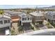 Aerial view of a home showcasing solar panels, a two-car garage, and a landscaped yard at 6611 Dove Point Pl, Las Vegas, NV 89130