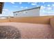 The gravel backyard has space for fun and leads to a covered patio for outdoor enjoyment at 6611 Dove Point Pl, Las Vegas, NV 89130