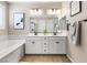 This stylish bathroom features a double sink vanity, framed mirror, and soaking tub for relaxation at 6611 Dove Point Pl, Las Vegas, NV 89130