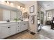 This bathroom features a double sink vanity, framed mirror, with door to the main bedroom at 6611 Dove Point Pl, Las Vegas, NV 89130