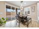Cozy dining area with sliding glass doors to the backyard, modern lighting, and tile flooring at 6611 Dove Point Pl, Las Vegas, NV 89130